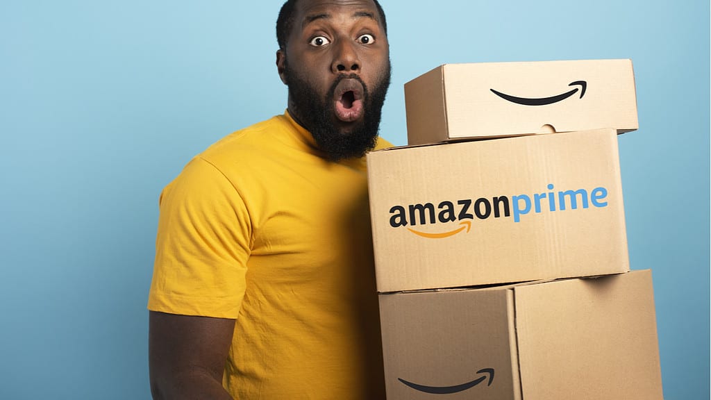 Man holding Amazon Prime parcels.