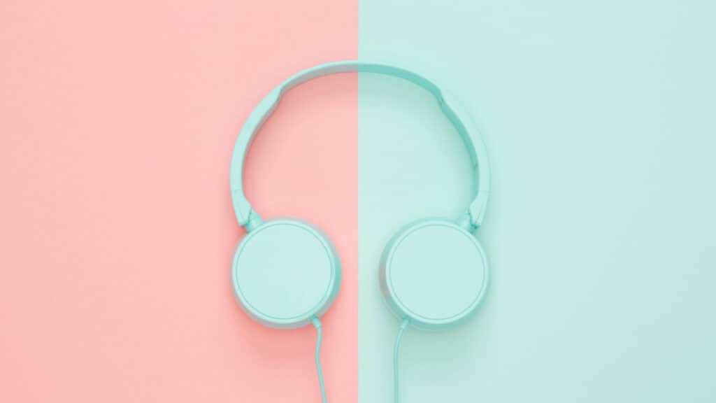 background half pink and half turquoise with a pair of turquoise headphones