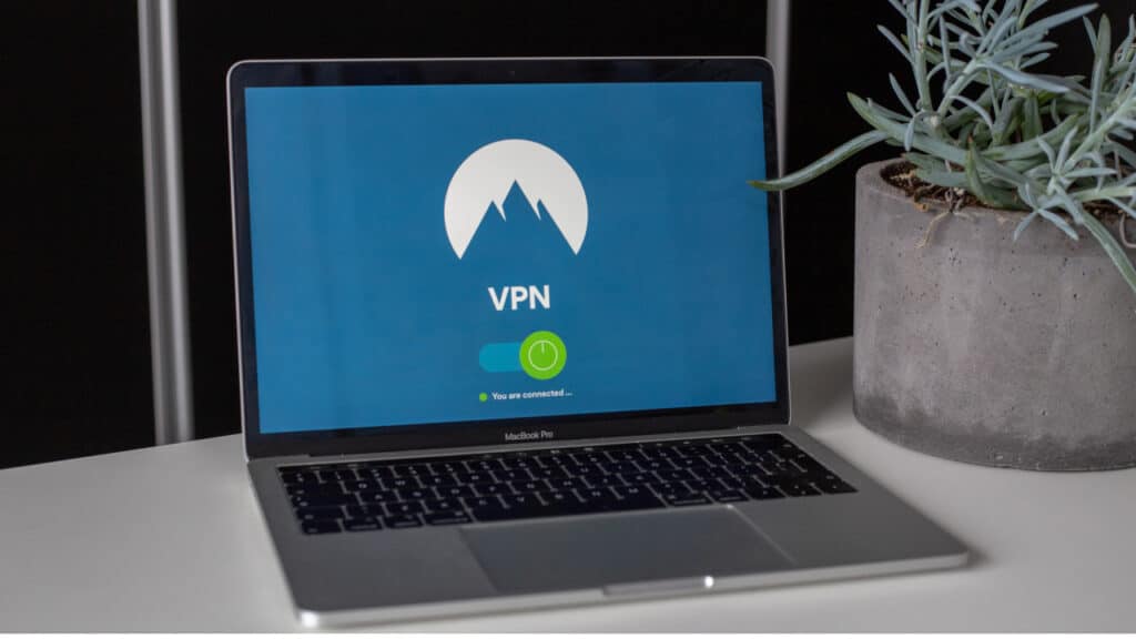 A laptop open showing the NordVPN logo and an on and off switch.