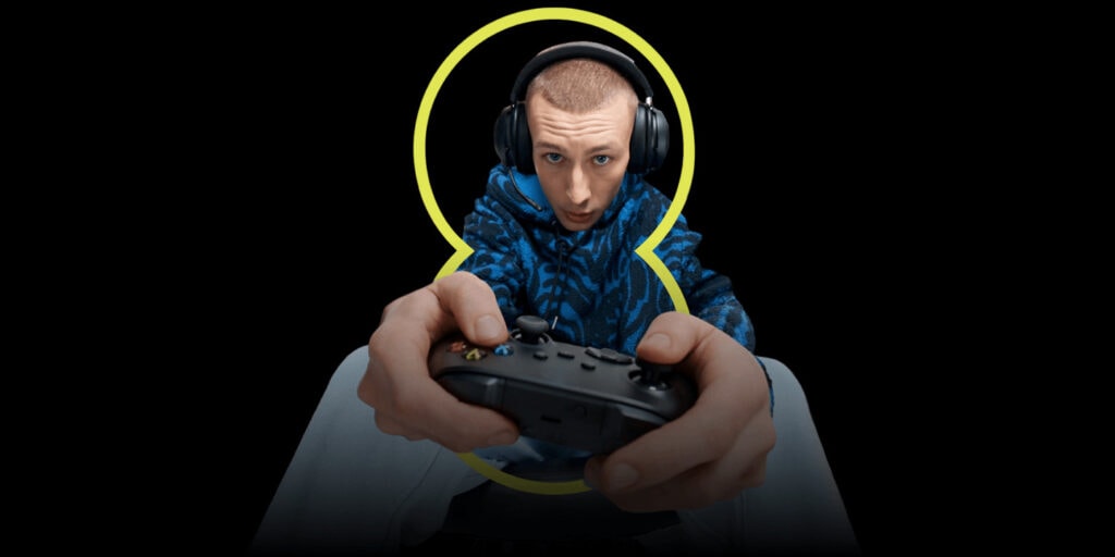 Man playing Xbox with EE logo enveloping him. 
